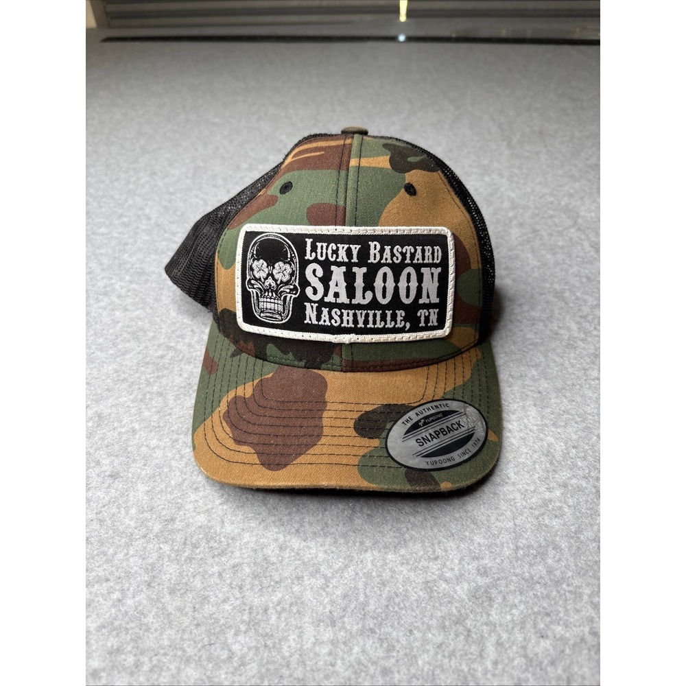 Yupoong Lucky Bastard Saloon Nashville TN Camo Trucker Hat Snapback Mesh Cap